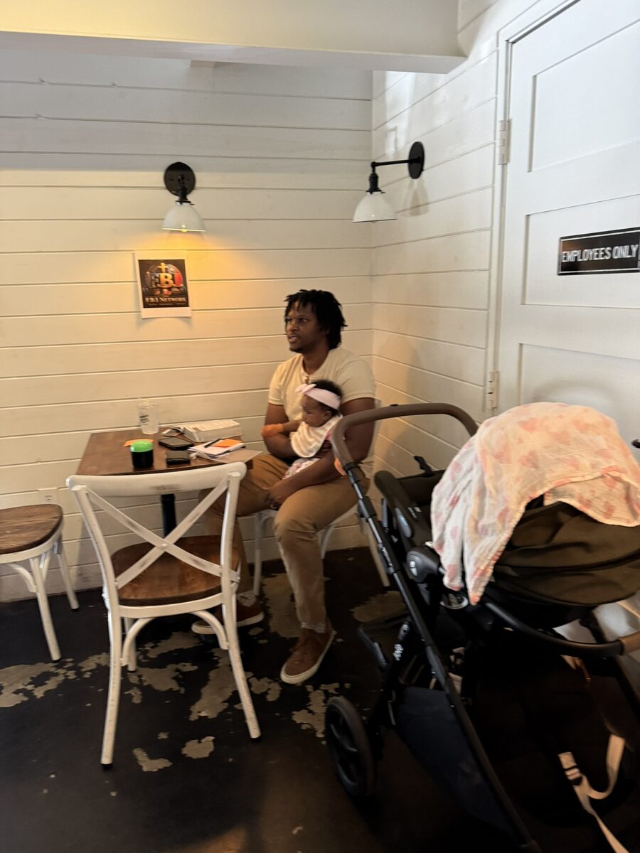 A Change Agent holding his daughter at the FBI Network launch meeting